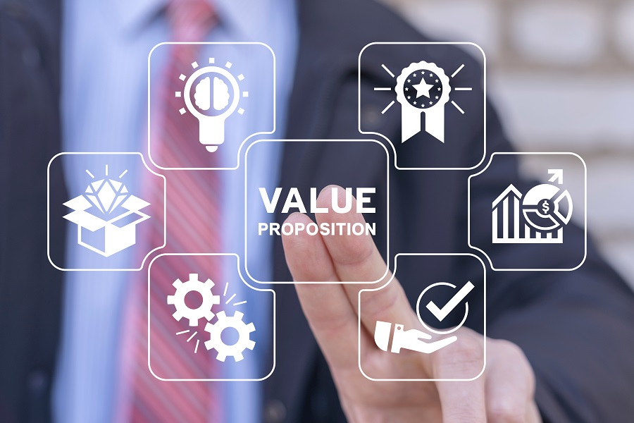 Professional interacting with a value proposition diagram: central value proposition label with surrounding icons for ideas, quality, growth, process, and trust